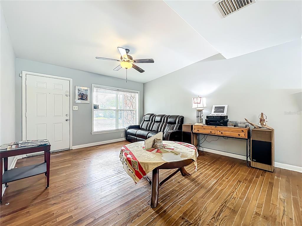 1700 Edmundshire Road Orlando, FL 32812 - Photo 8 of 43 a living room with furniture and a wooden floor