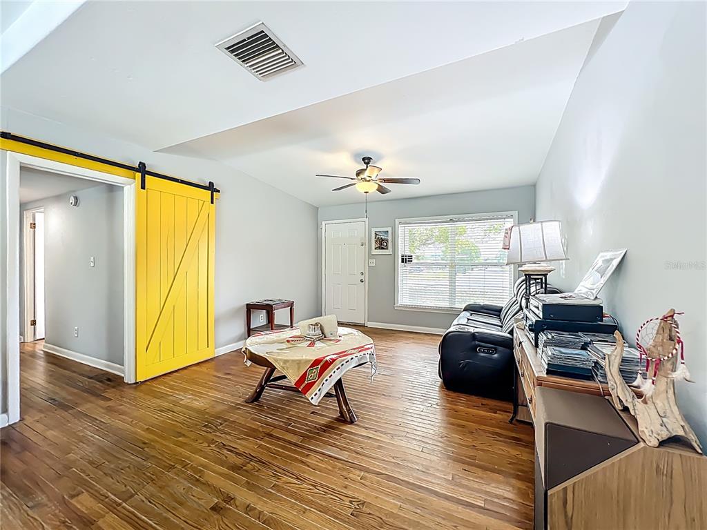 1700 Edmundshire Road Orlando, FL 32812 - Photo 9 of 43 a living room with furniture windows and wooden floor