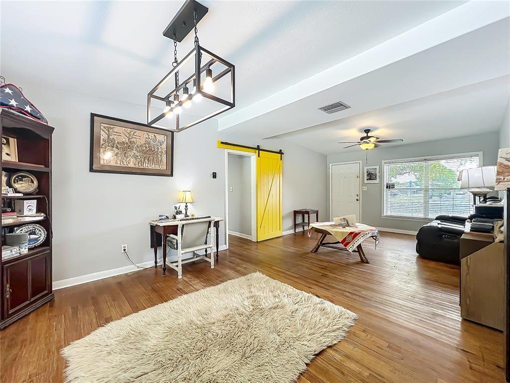 1700 Edmundshire Road Orlando, FL 32812 - Photo 10 of 43 a living room with furniture and wooden floor