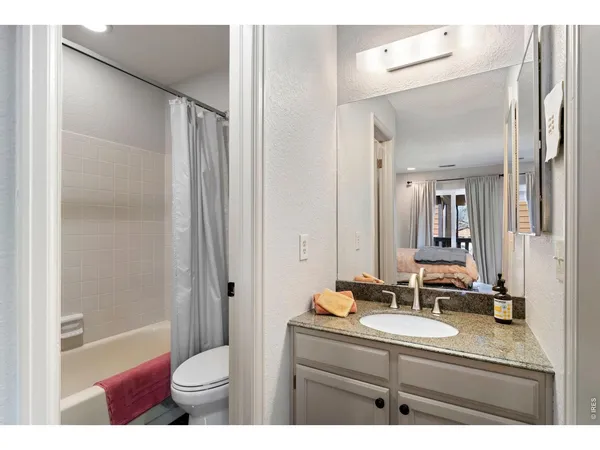 a bathroom with a sink toilet a mirror and shower