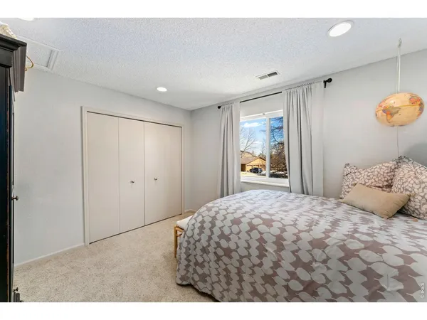 a bedroom with a large bed and a window