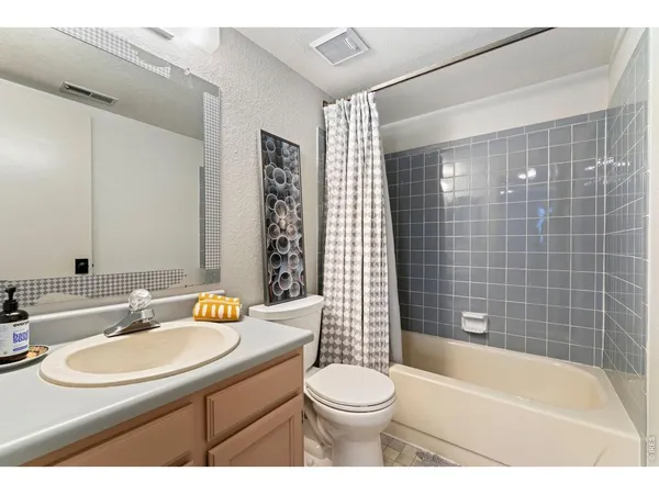 a bathroom with a sink a toilet and bathtub
