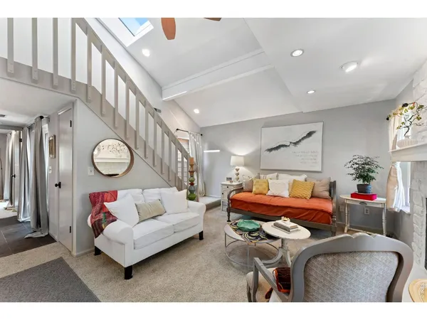 a living room with furniture a rug and a chandelier