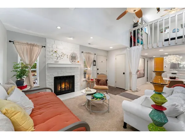 a living room with furniture and a fireplace