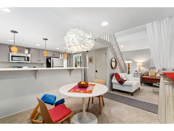 a living room with furniture kitchen view and a table