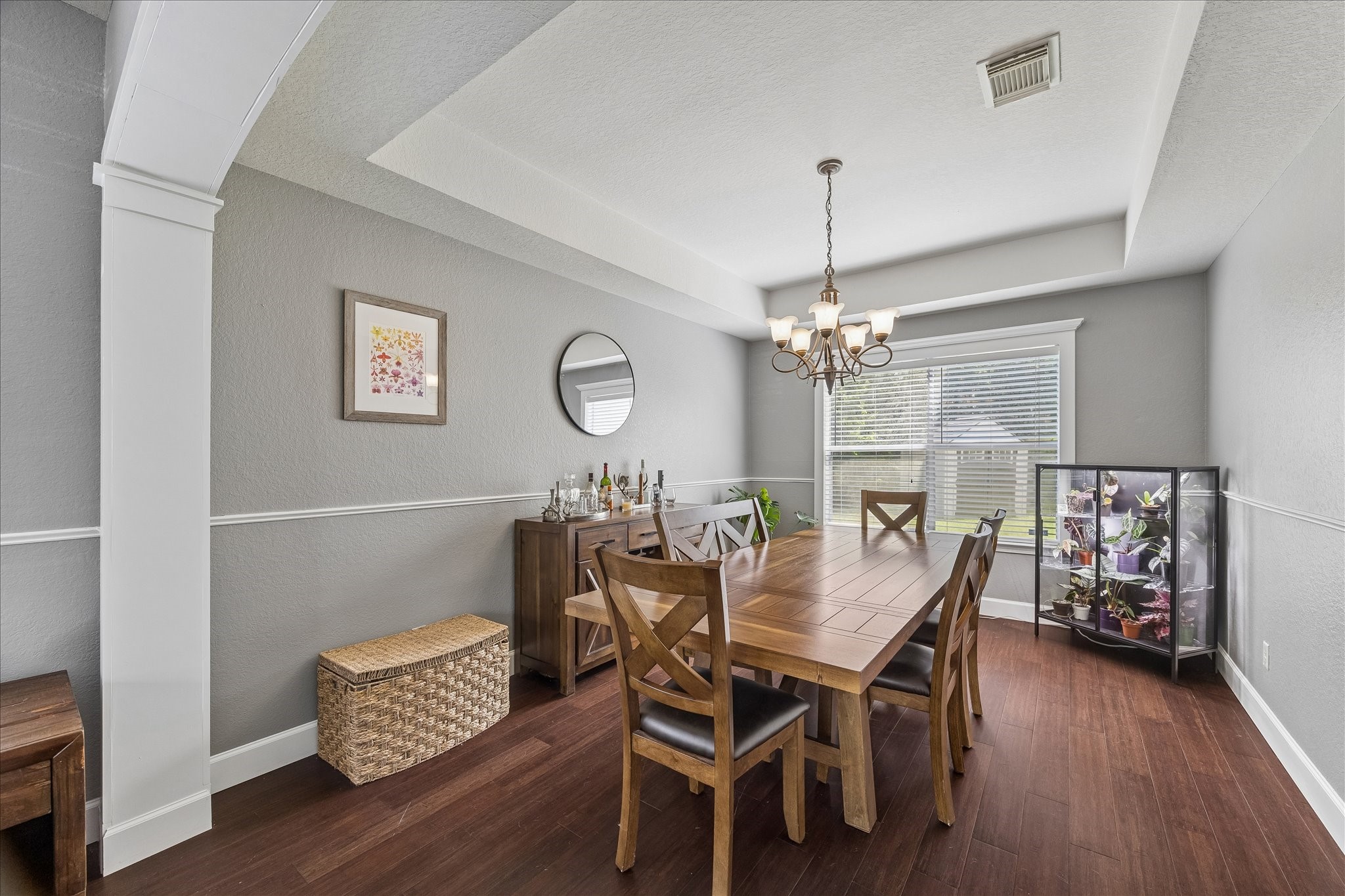 23234 Grand Rapids Lane Spring, TX 77373 - Photo 9 of 30 Sophisticated dining room offers rich hardwood floors, a tray ceiling, and an open flow into the kitchen — perfect for entertaining.