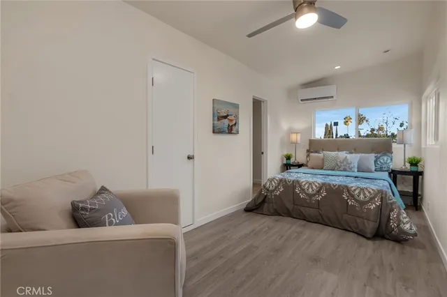 a spacious bedroom with a bed and a couch