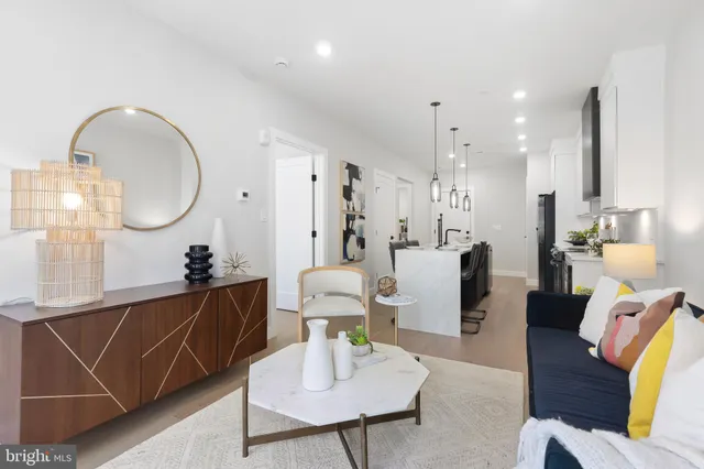 a living room with furniture a mirror and a chandelier
