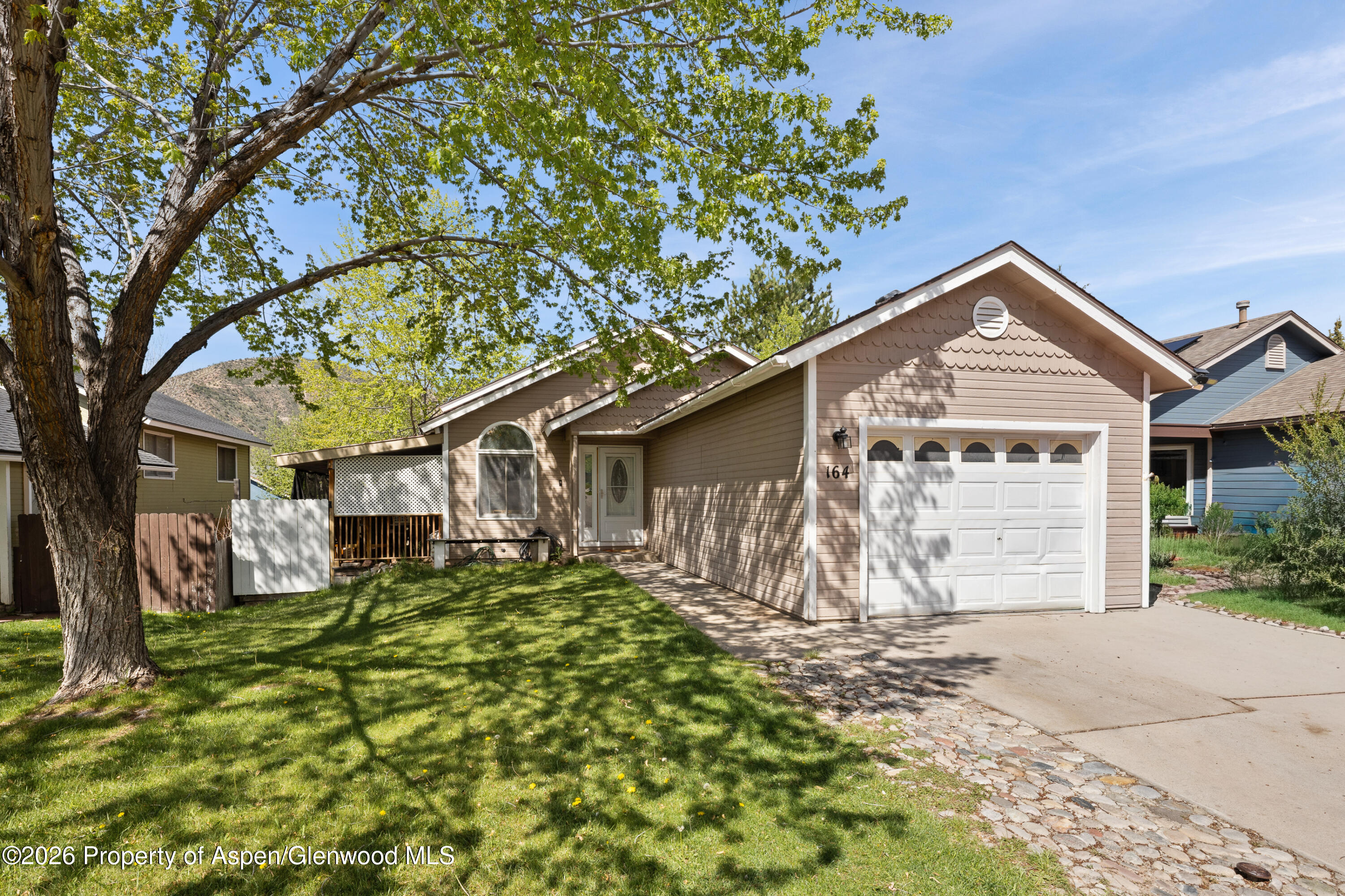 164 Current Drive New Castle, CO 81647 - Photo 1 of 34 a front view of a house with a yard and garage