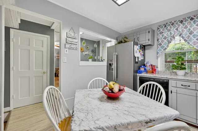 a view of a workspace with furniture and wooden floor