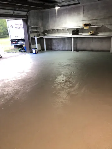 a view of a yard with wooden fence