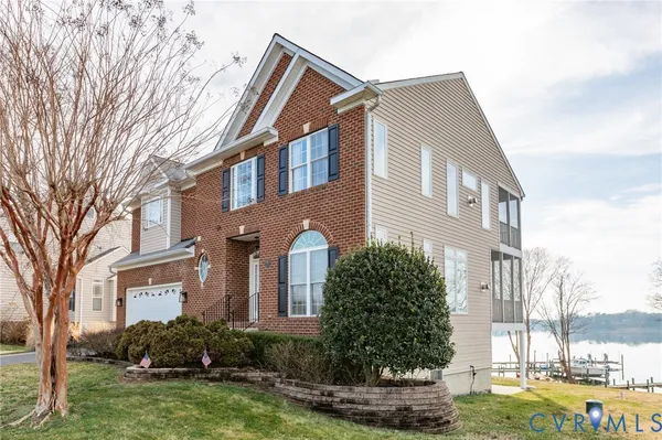 a front view of a house with a yard and trees