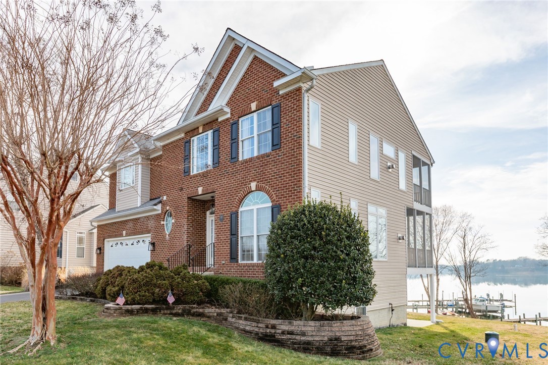 a front view of a house with a yard and trees