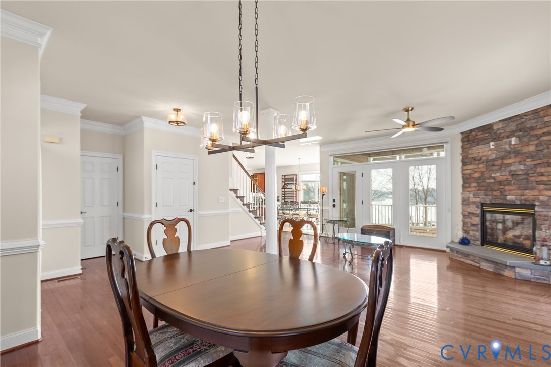 175 Shellfield Lane Colonial Beach, VA 22443 - Photo 20 of 100 a dining room with furniture wooden floor a rug and a chandelier