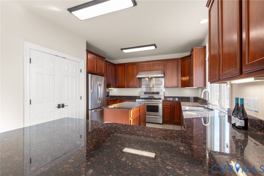 175 Shellfield Lane Colonial Beach, VA 22443 - Photo 27 of 100 a kitchen with stainless steel appliances granite countertop a refrigerator stove and sink