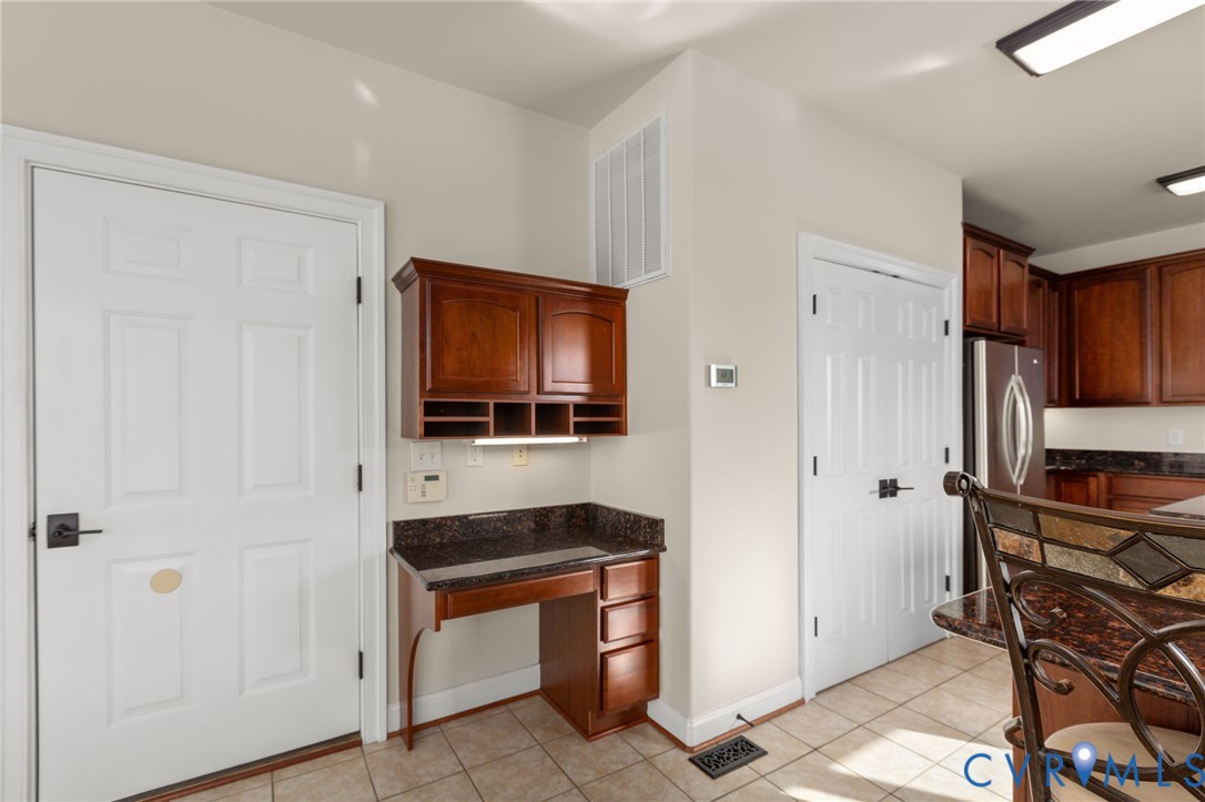 175 Shellfield Lane Colonial Beach, VA 22443 - Photo 28 of 100 Kitchen with dark stone counters, freestanding ref