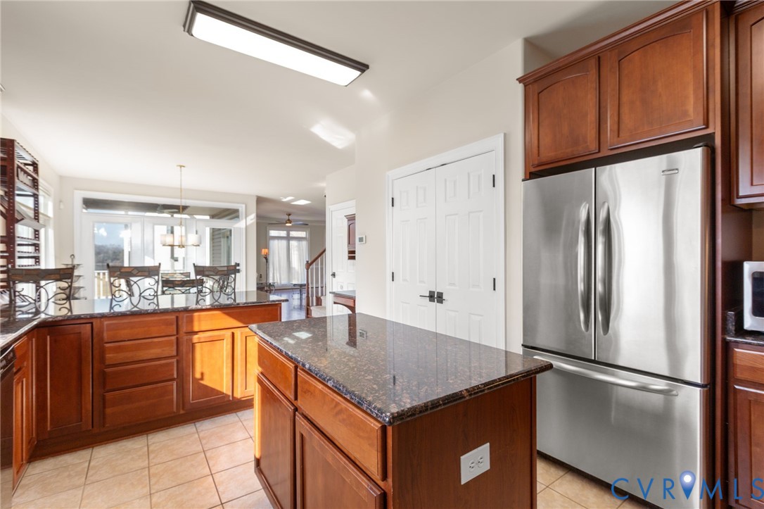 175 Shellfield Lane Colonial Beach, VA 22443 - Photo 31 of 100 a kitchen with stainless steel appliances granite countertop a refrigerator a sink and white cabinets