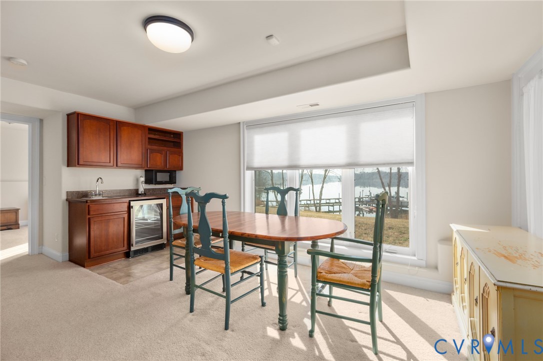 175 Shellfield Lane Colonial Beach, VA 22443 - Photo 60 of 100 a view of a dining room with furniture a kitchen and chandelier