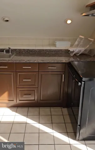 a bathroom with a black and white checkered floor