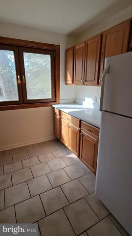 a kitchen with a sink a stove and a refrigerator