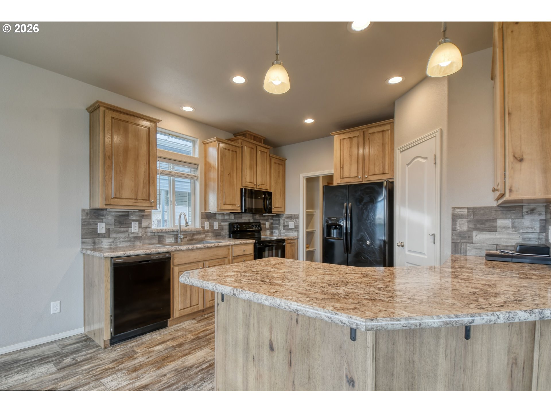 105 Columbia Street Helix, OR 97835 - Photo 11 of 34 a kitchen with kitchen island granite countertop a stove sink and refrigerator
