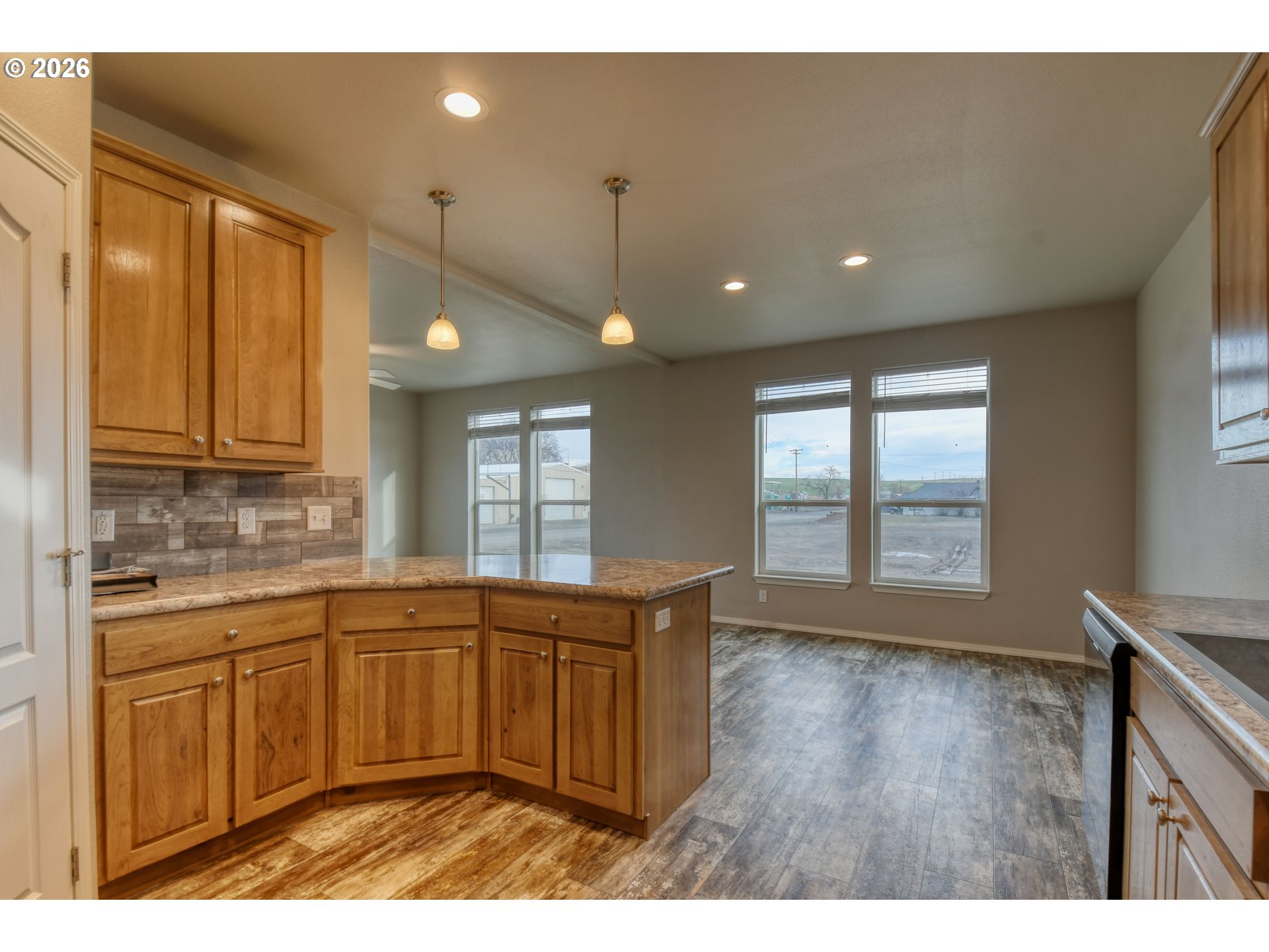 105 Columbia Street Helix, OR 97835 - Photo 13 of 34 a kitchen with stainless steel appliances granite countertop a sink a stove and a wooden floors