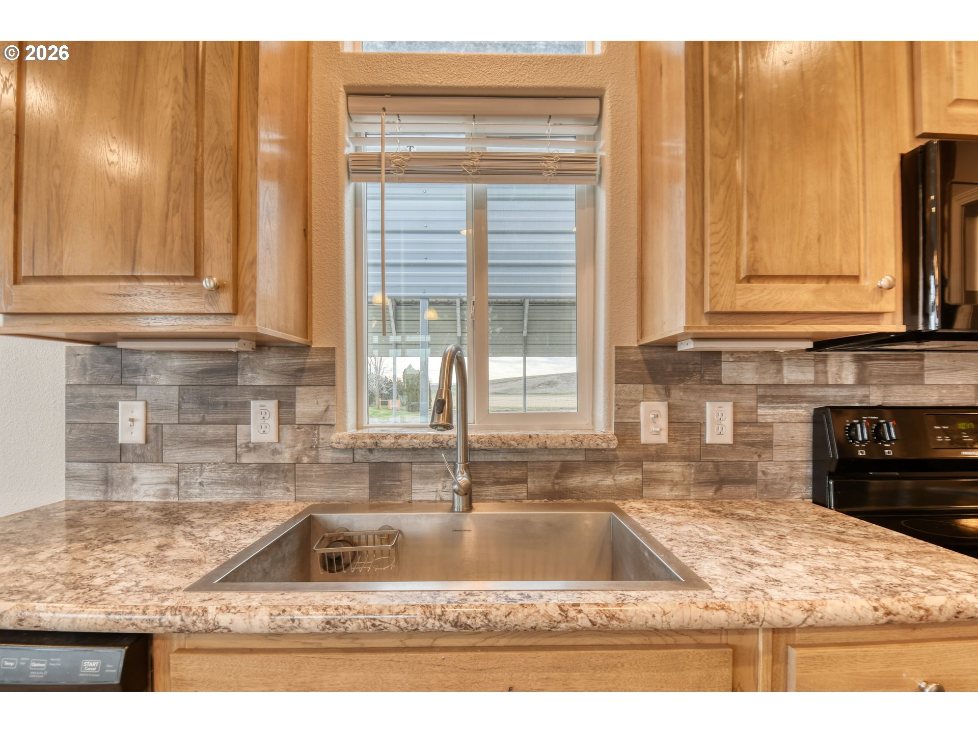 105 Columbia Street Helix, OR 97835 - Photo 15 of 34 a kitchen with granite countertop a sink and a window