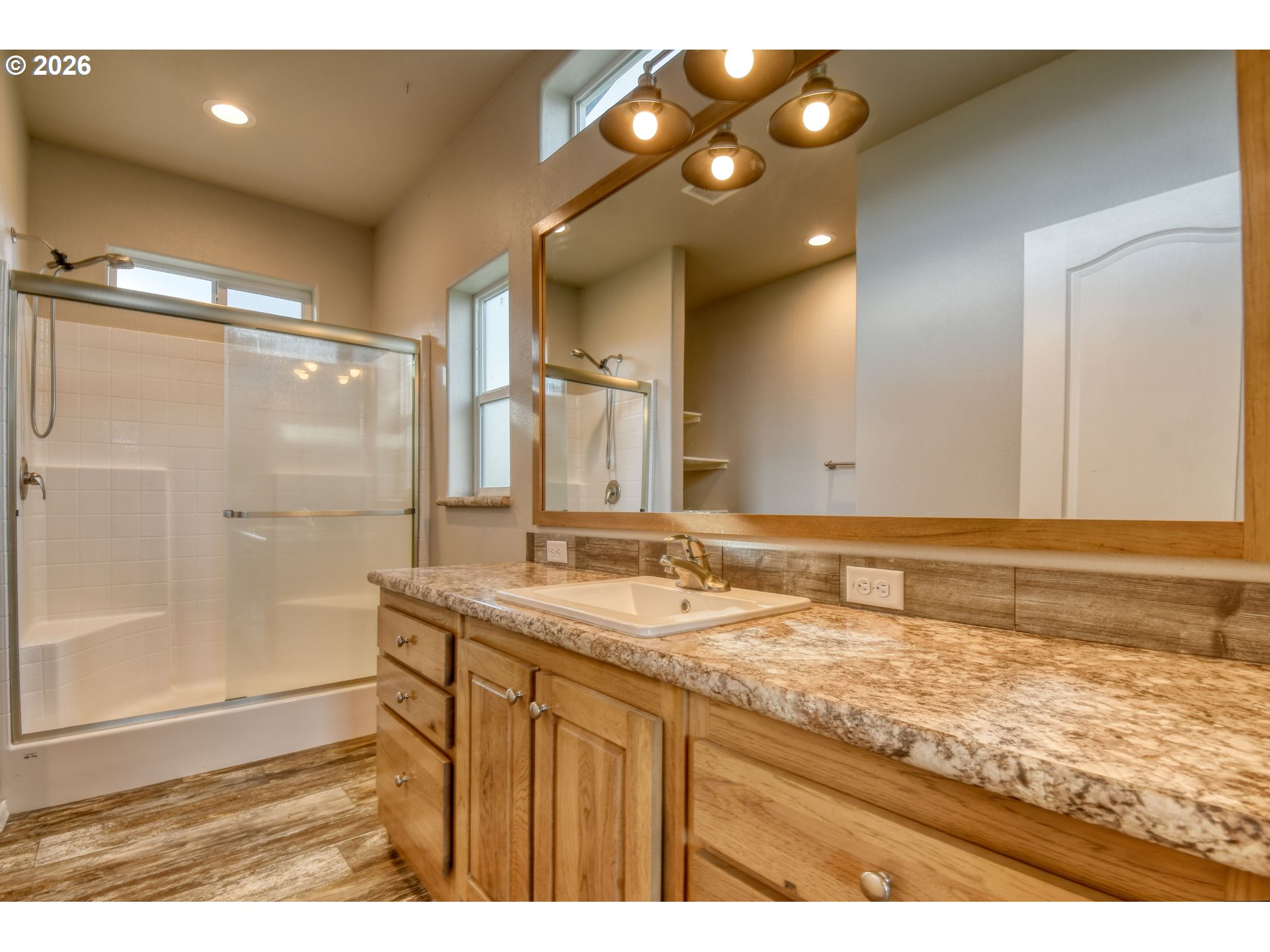 105 Columbia Street Helix, OR 97835 - Photo 19 of 34 a bathroom with a granite countertop sink a mirror and a shower