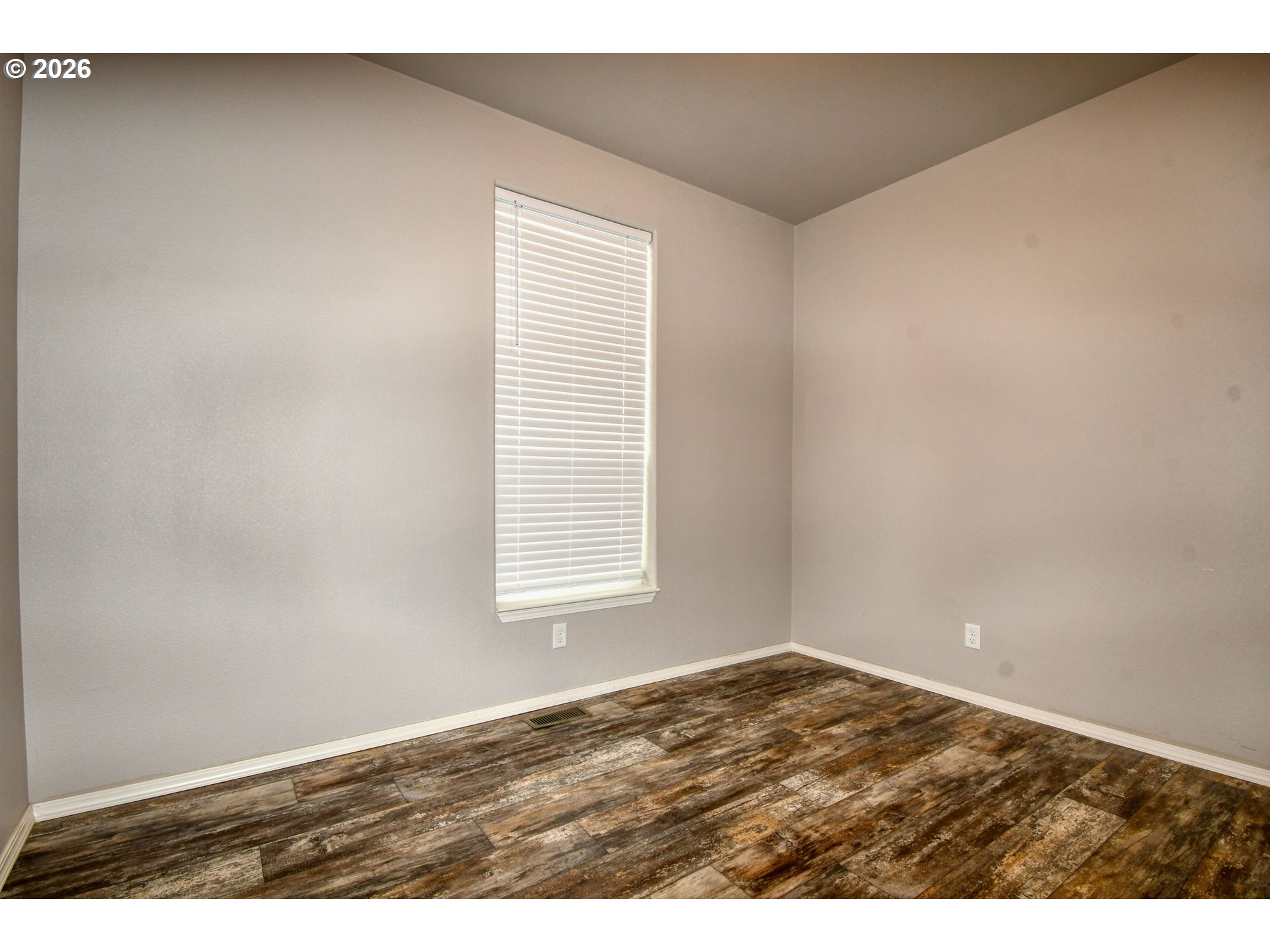 105 Columbia Street Helix, OR 97835 - Photo 22 of 34 an empty room with wooden floor and windows