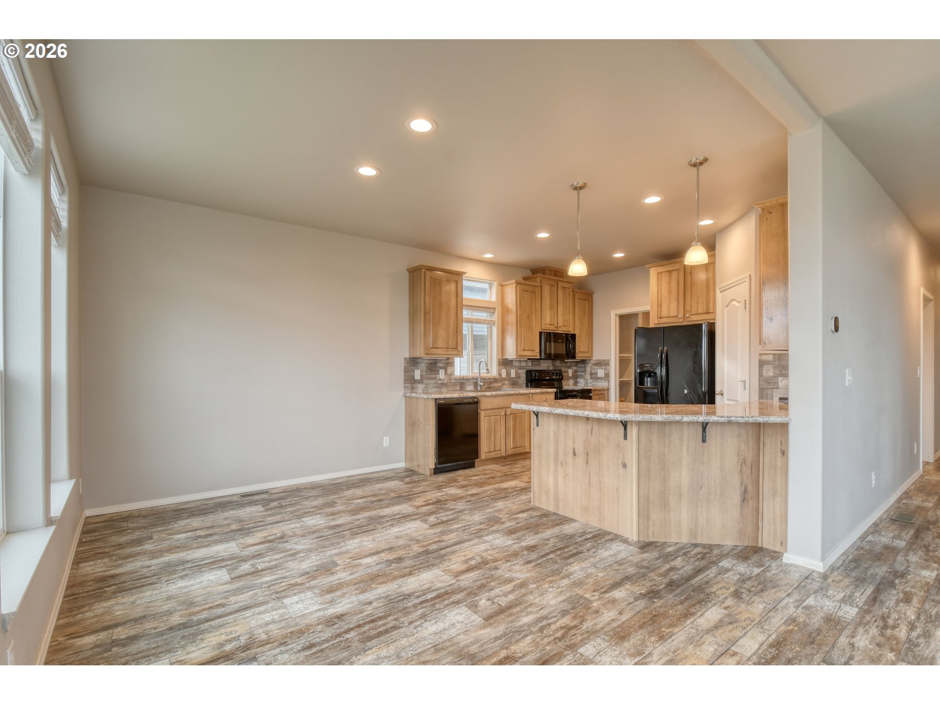 105 Columbia Street Helix, OR 97835 - Photo 10 of 34 a view of kitchen with kitchen island a sink wooden floor and stainless steel appliances