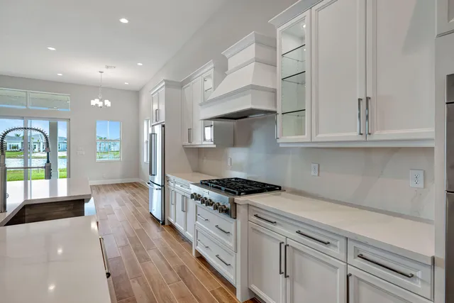 a kitchen with sink a stove and cabinets