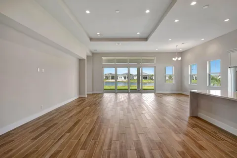 a living room with furniture and large windows