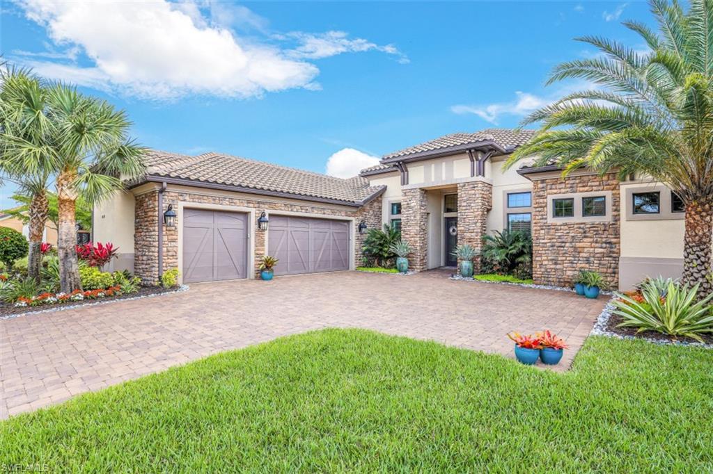 a front view of a house with a yard and garage