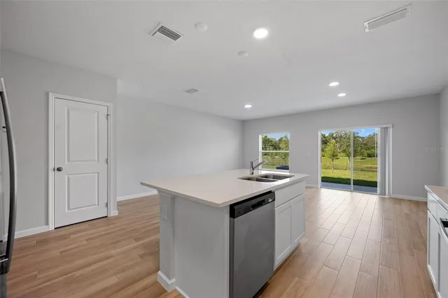 a kitchen with a stove and a wooden floor