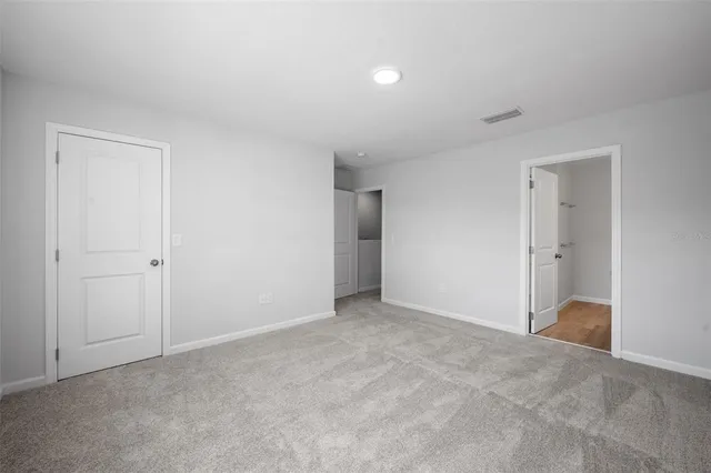 a view of an empty room and closet area