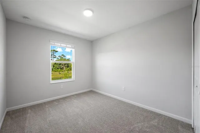 an empty room with windows and plants