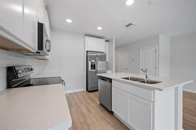 a kitchen that has a sink and a stove in it