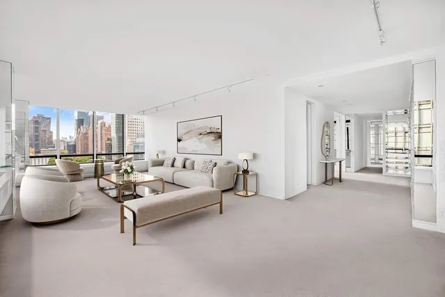 a living room with furniture and large windows