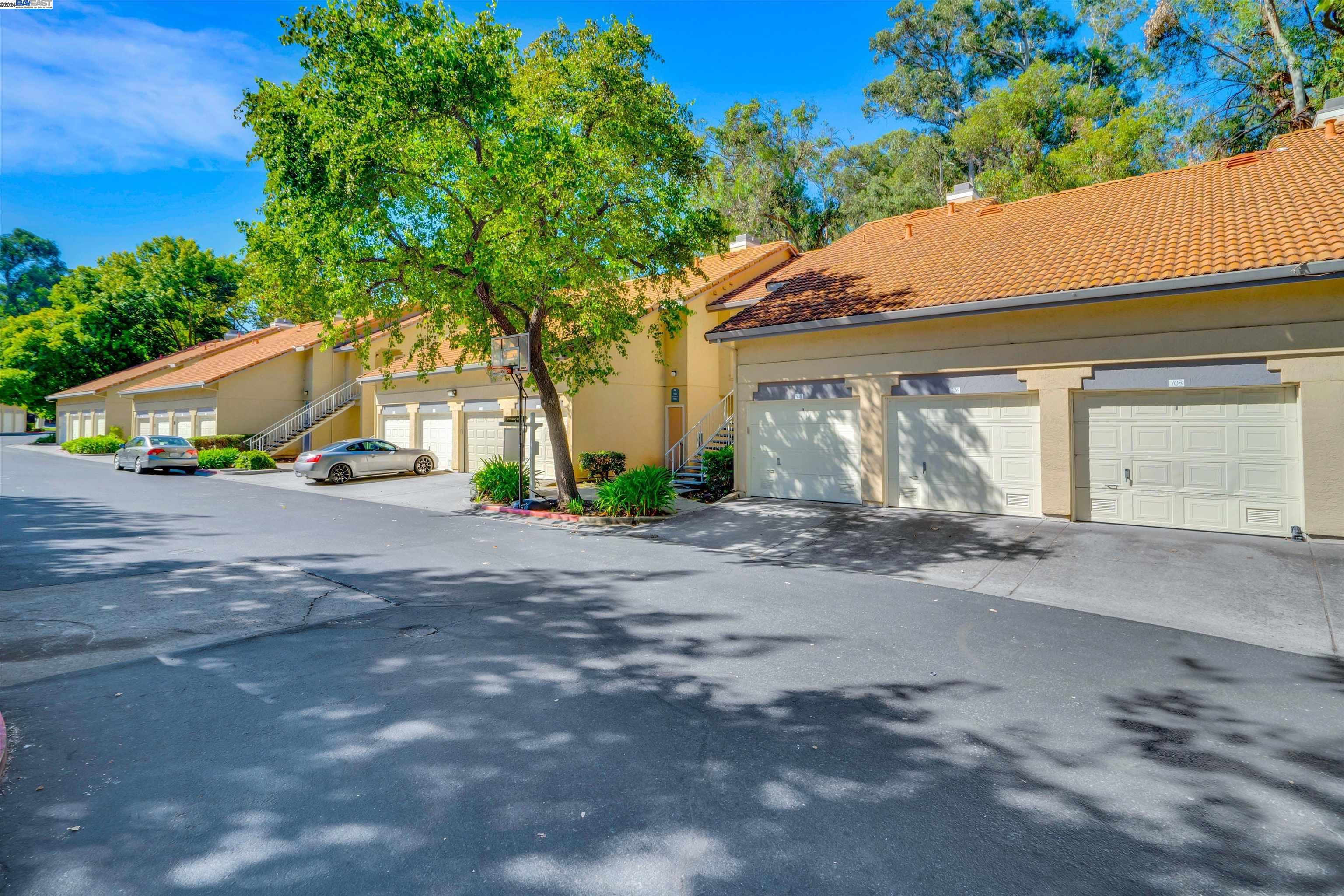 a view of road and car parked in front of house
