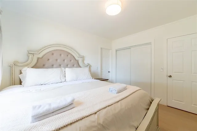 a bedroom with a bed and a closet