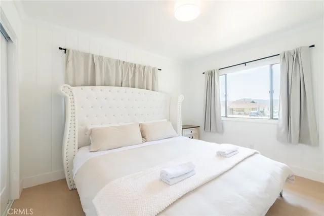 a bedroom with a large bed and a window