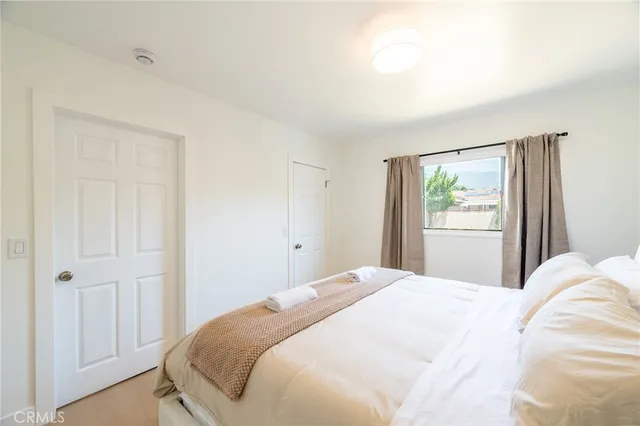 a bedroom with a bed and a window