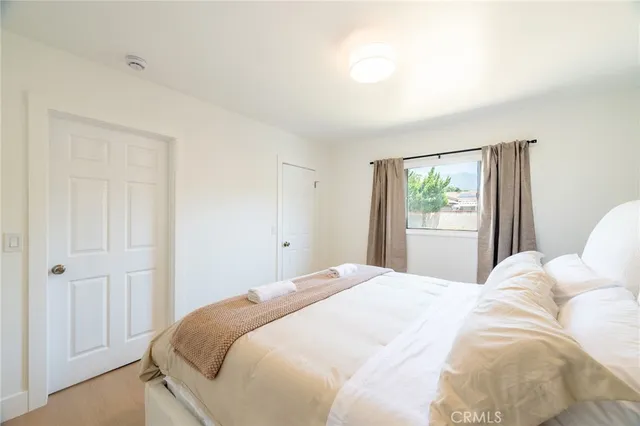 a bedroom with a bed and a window