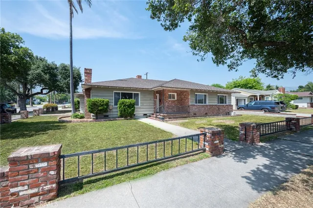 a view of a house with a yard and sitting area