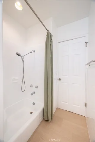 a bathroom with a bathtub and a shower