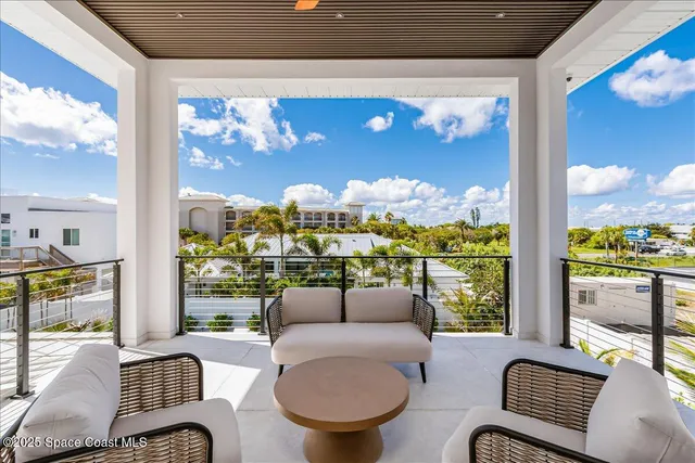 a view of a patio with a table and chairs