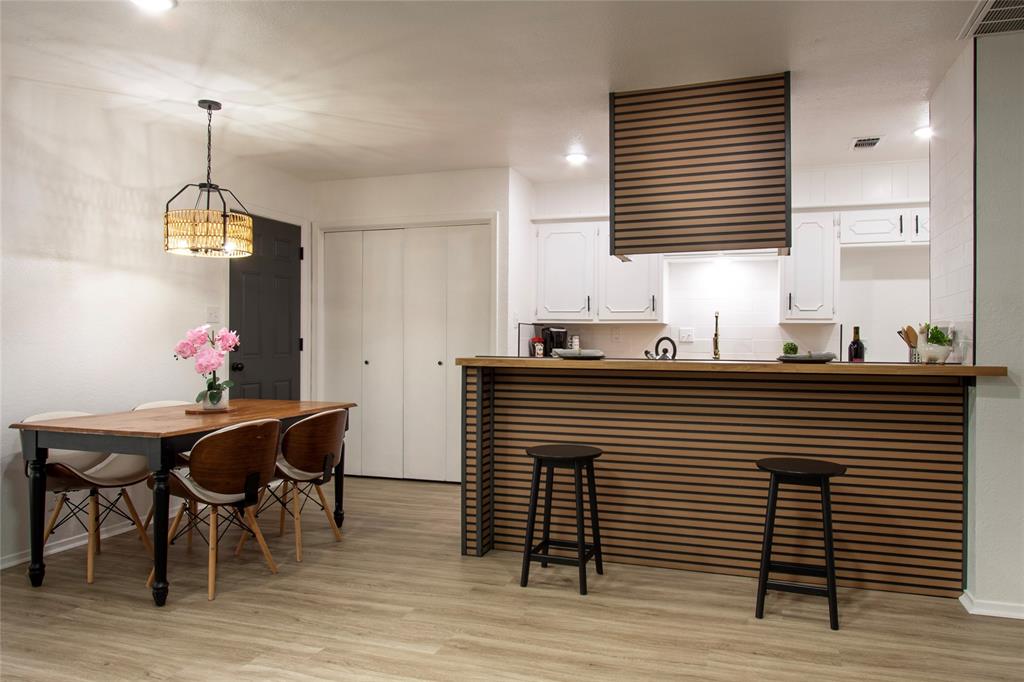 1205 Augusta Road Benbrook, TX 76126 - Photo 4 of 21 Kitchen bar with horizontal wood slat detailing and a coordinating wood countertop