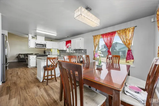 a dining room with furniture and window