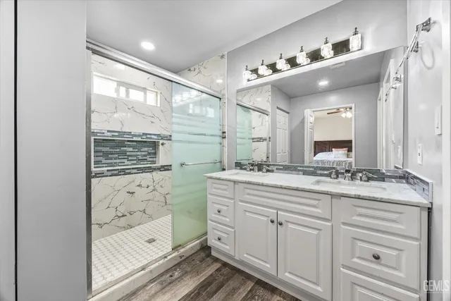 a bathroom with a double vanity sink and mirror