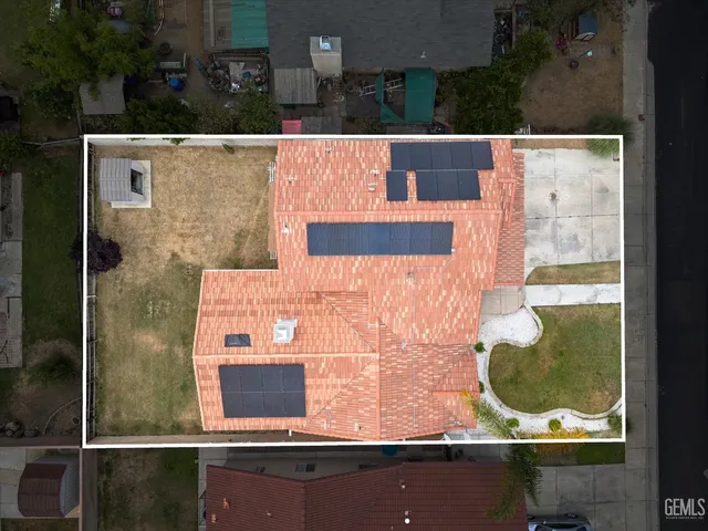 an aerial view of a residential houses with swimming pool and outdoor space